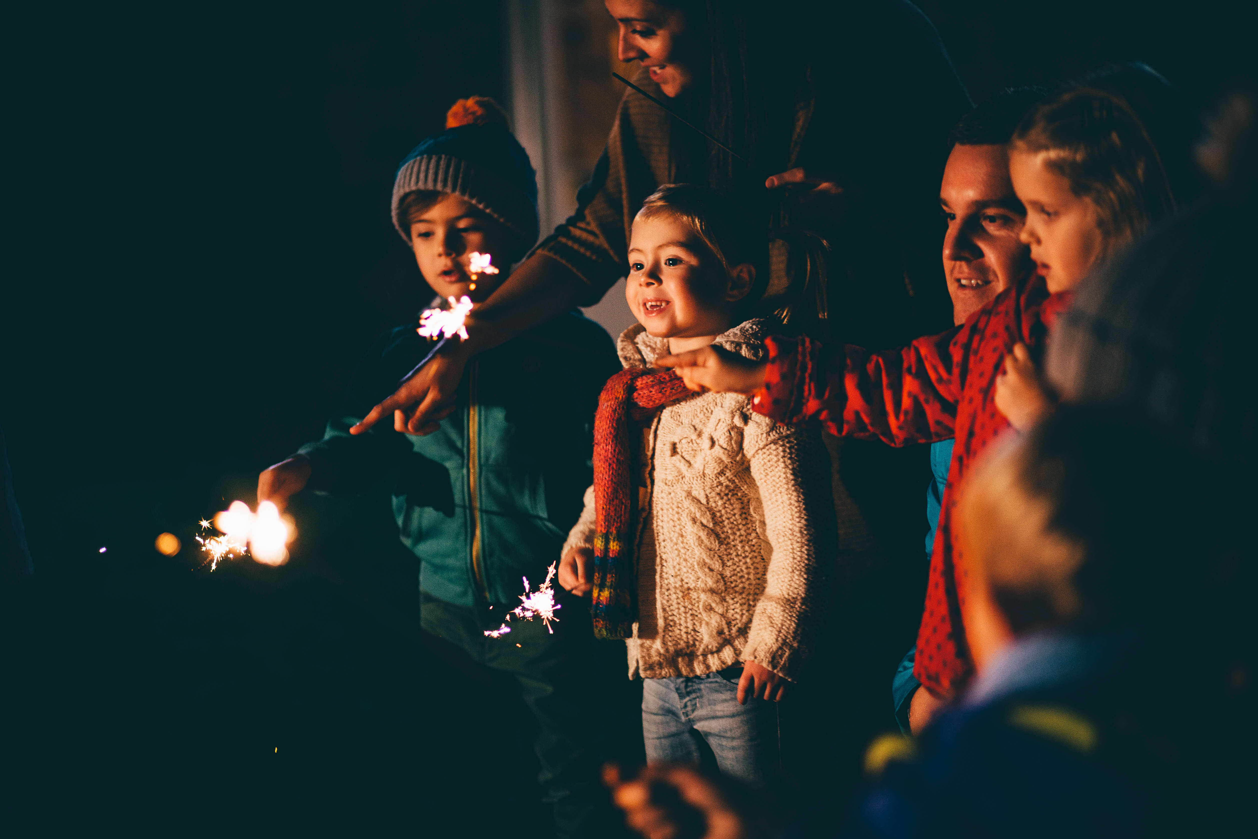 At Reykjavik bonfires crowds gather & friends chat. Children run around with sparklers and small flares.